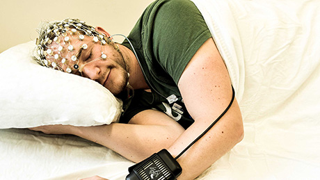  Ein Proband testet das Tiefschlaf-​Stimulationssystem. (Bild: Stephanie Huwiler & Silvia Hofer / ETH Zürich) 