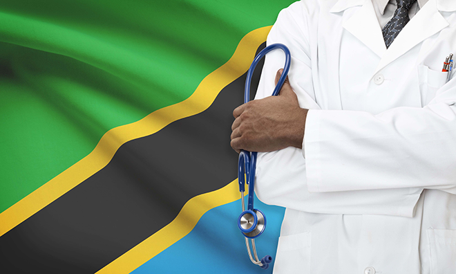 Doctor standing in front of the flag of Tanzania