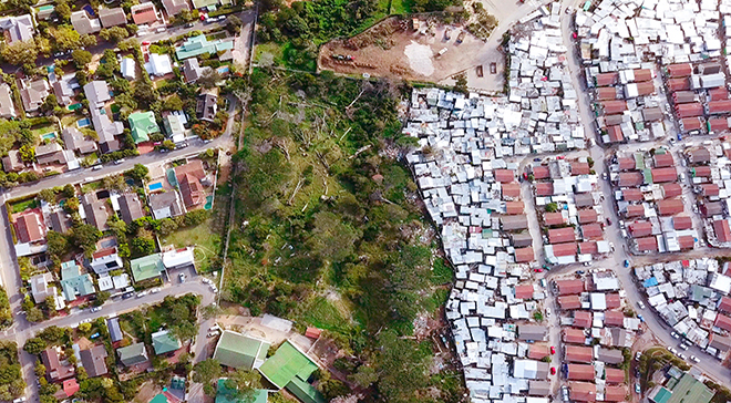 Aerial view of an informal settlement and more affluent suburbs in South Africa.